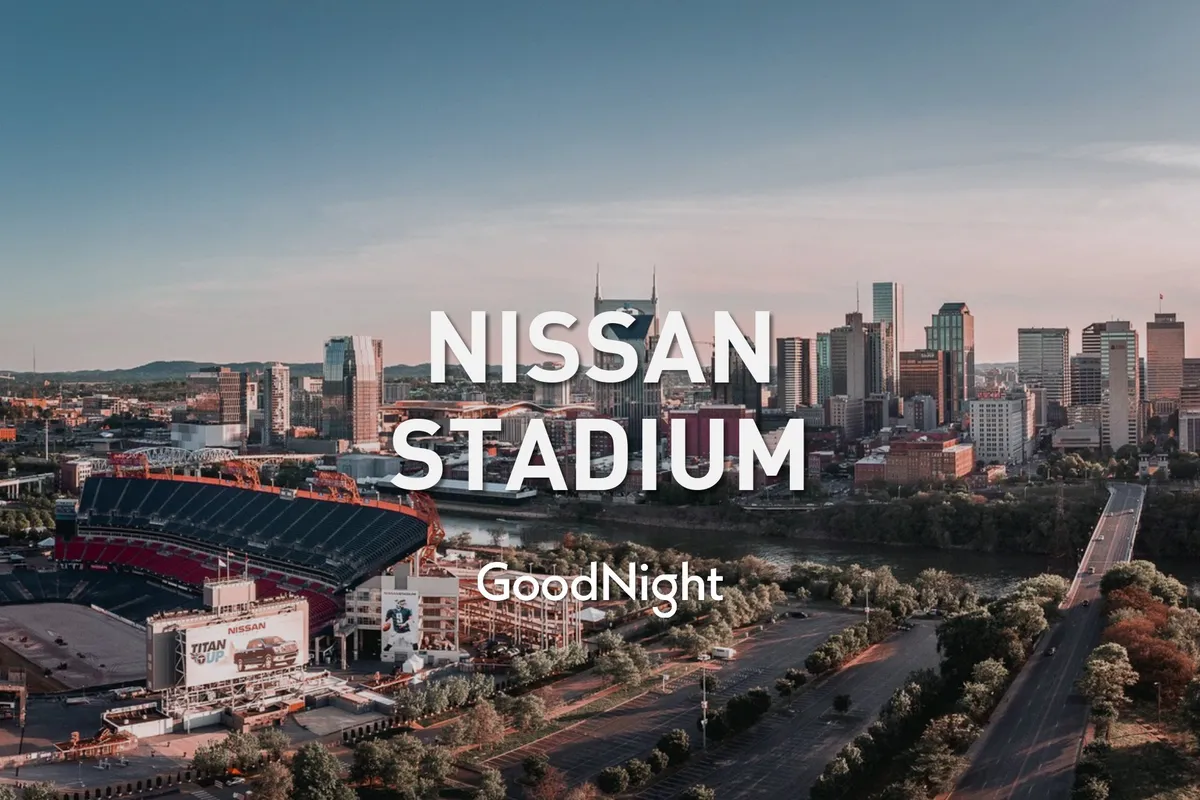 A sweeping view featuring Nissan Stadium along the riverfront with the downtown Nashville skyline in the background. The tranquil river and city lights set the stage for memorable evenings out, while the stadium connects to major concerts and events referenced in the text.